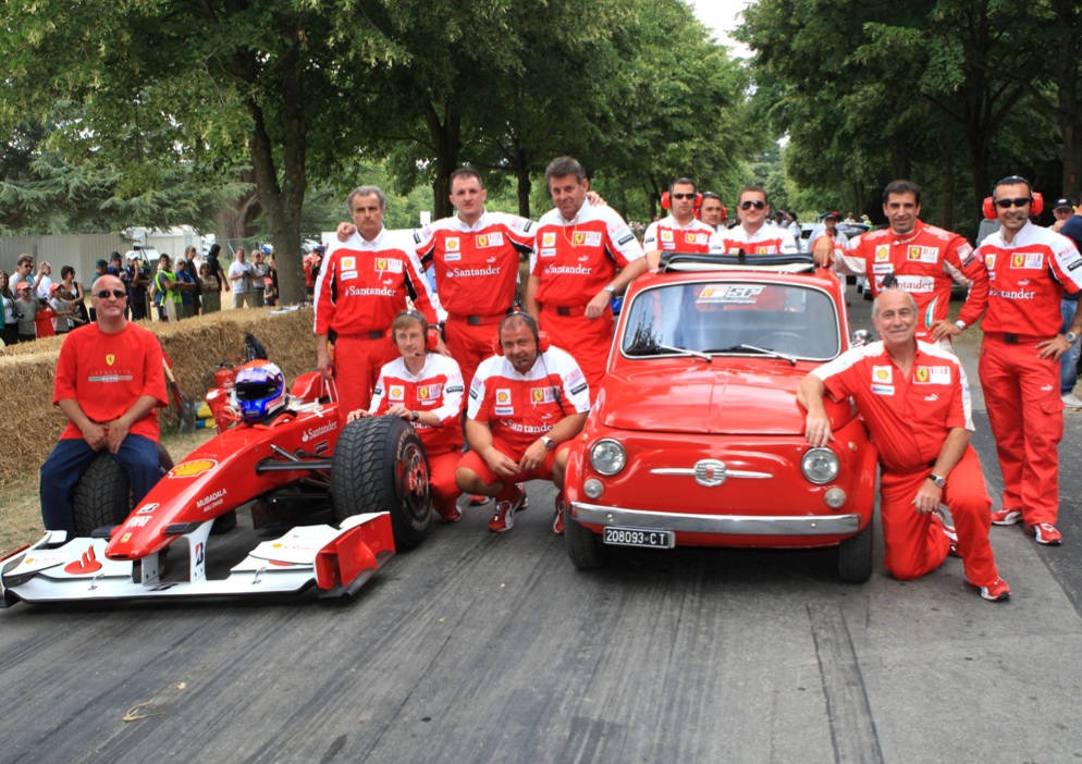 Toto far left and Vittorio far right kneeling with Ferrari Team and Kimi Raikkonnen's 2009 F1 car driven at Goodwood by Ferrari Test Driver Marc Gené (standing behind Vittorio) width=
